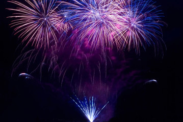 Blue colorful fireworks on black night sky background