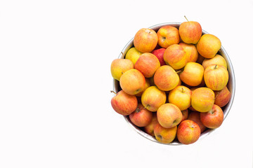 mountain of juicy bright apples in an aluminum basin isolate