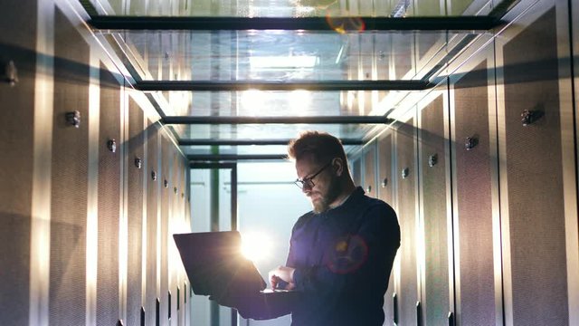Datacenter unit and IT specialist navigating a laptop