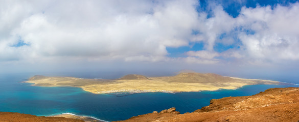 Scenery of volcanic Lanzarote - panoramic view from Mirador del Rio for island Graciosa. Canary islands