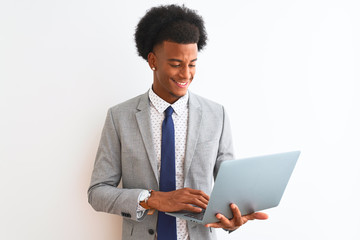 Young african american businessman using laptop standing over isolated white background with a happy face standing and smiling with a confident smile showing teeth