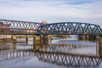Railroad bridges across the Billhafen at the north-east end of the inland port in Hamburg. The water canal is an anabranch of the Elbe river