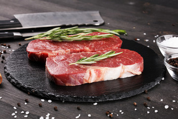 Steak raw. Barbecue Rib Eye Steak or rump steak on dark rustic table