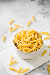 Pasta in a white bowl on a light gray table