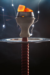  smoky red hookah on a black background, and around a cloud of tobacco smoke