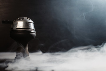  on a black background in smoke is a bowl with colaud and coals