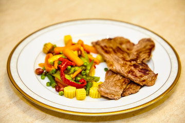 Roast beef with vegetables lie on a plate