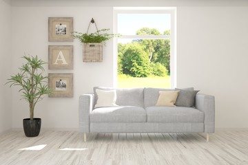 Naklejka premium Stylish room in white color with sofa and summer landscape in window. Scandinavian interior design. 3D illustration