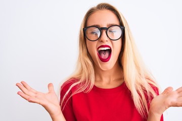 Young beautiful woman wearing red t-shirt and glasses standing over isolated white background...