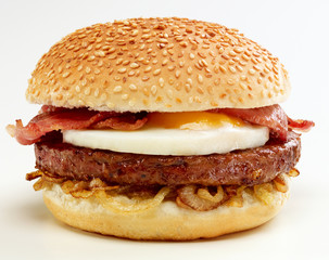 Homemade Breakfast Burger with beef pate, fried egg, onions and Bacon