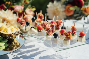 Delicious snacks on wedding reception table in luxury outdoor restaurant
