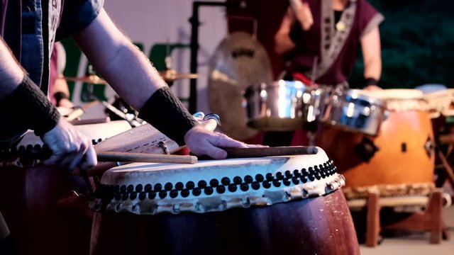 Taiko drummers during performance. Static. Low POV. Blur