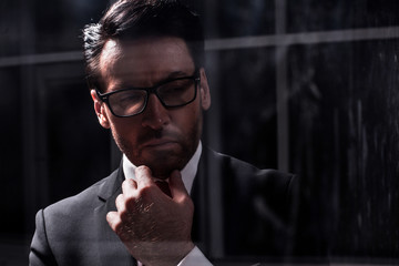 close up.businessman standing in a dark office.