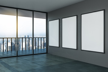 Blank white mock up posters on grey wall in modern empty room with balcony and city view.