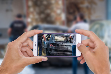 Car crash accident damaged with hand using smartphone taking photo