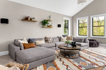 Fotobehang Hotel chique Beautiful living room in new luxury home. Features L shaped sectional sofa, area rug, and elegant decor  © bmak