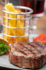closeup of grilled steak with french fries