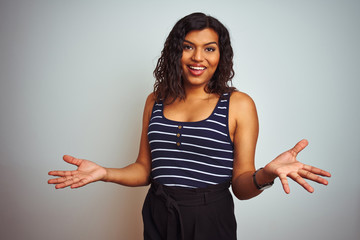 Transsexual transgender woman wearing striped t-shirt over isolated white background smiling cheerful with open arms as friendly welcome, positive and confident greetings