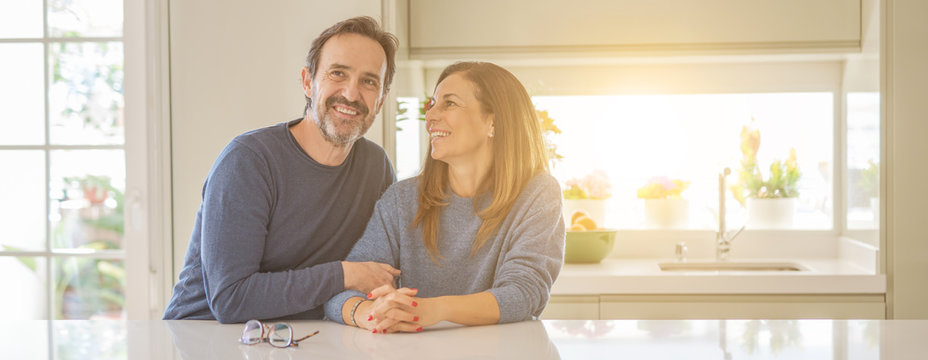 Romantic middle age couple sitting together at home