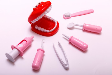 Teeth brush and jaw copy space. Prevention and care children's teeth on white wooden background. Top view. Child dentist concept toy.