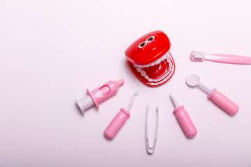 Teeth brush and jaw copy space. Prevention and care children's teeth on white wooden background. Top view. Child dentist concept toy.