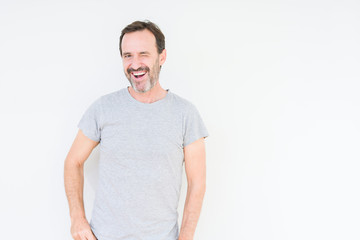 Handsome senior man over isolated background winking looking at the camera with sexy expression, cheerful and happy face.