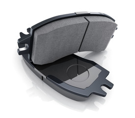 Two black brake pads on white background