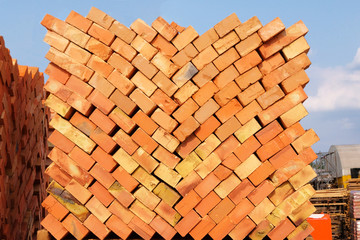 Construction Materials. Building materials for construction of building s and structures. Pile of red bricks at construction site.