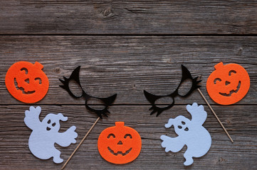 Silhouette of scary pumpkin, ghosts, black cat mask - concept for Halloween on vintage wooden background