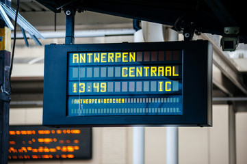 Electronic arrival departure board with city name and track inside Oostende railway station in Belgium with destination to Antwerpen Centraal