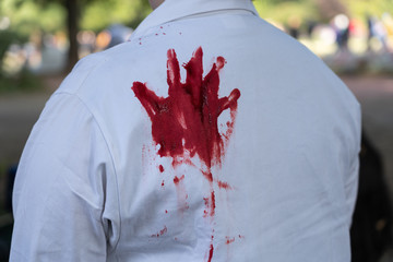 Bloody handprint on a white coat
