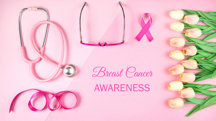 Pink Ribbon Breast Cancer Awareness Month concept flat lay on pink background.