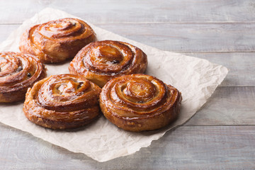 sweet pastries on a baking sheet. cakes on a wooden background