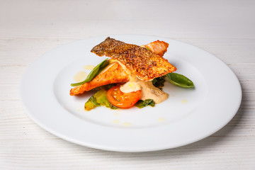 Salmon steak with creamy sauce and vegetables