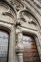 Obraz premium May holding Jesus statue above the entrance of Neo-Gothic Sint-Petrus-en-Pauluskerk the main church of Ostend, Belgium a Roman Catholic church