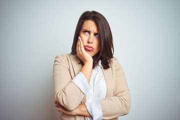 Young beautiful elegant business woman over isolated background thinking looking tired and bored with depression problems with crossed arms.