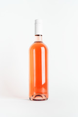 Rose wine bottle for Mock-up blank label product on white .background. Minimal colorful layout concept of summer time alcohol beverage.