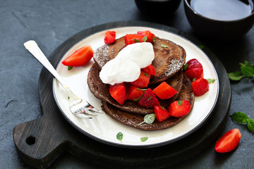 Chocolate pancakes with berries.