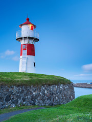 Fototapeta na wymiar Lighthouse with pathway on Torchaven city on Faroe islands Big size