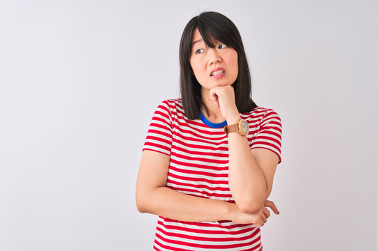 Young beautiful chinese woman wearing red striped t-shirt over isolated white background Thinking worried about a question, concerned and nervous with hand on chin
