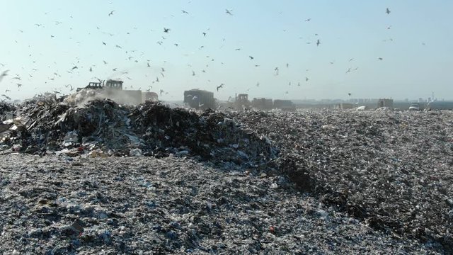 modern bulldozers work on large garbage dump top aerial view