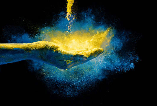 Magical colored dust exploding from a hand. Holi Festival