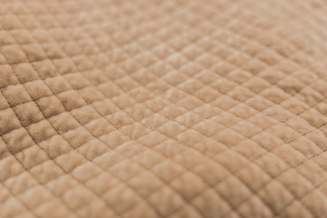 Beige plush fabric used for background. Photo with selective focus