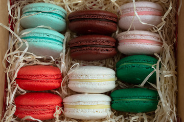 A gift box of colorful French macaroons. Close-up.