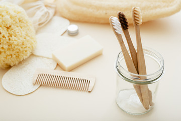 Zero waste and plastic free concept with bamboo tooth brush, towel, sea sponge, loofah, soap, wooden hair brush. Eco-friendly bathroom. Natural products.