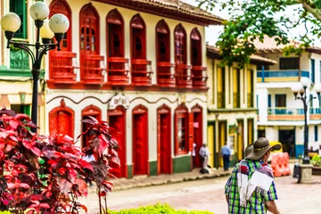 Fototapeten View on colorful red colonial buildings at central square of village Jerico in Colombia © streetflash