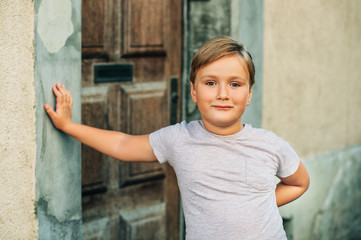 Outdoor portrait of handsom little boy with new haircut