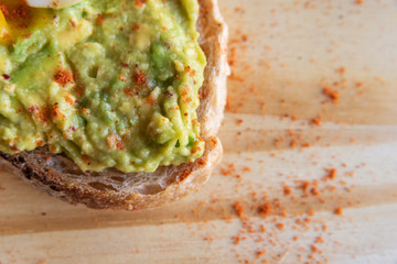 Avocado toast with egg on cutting board