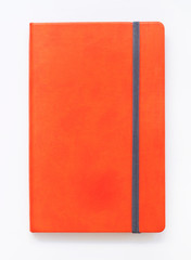 Orange closed notebook mockup isolated on white