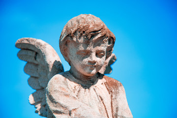 Obraz premium Ancient stone statue of little angel as symbol of guards for children